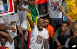 Ethiopians rally in solidarity with Prime Minister Abiy Ahmed, whose photo is seen on a participant’s T-shirt, in Meskel Square in the capital, Addis Ababa, Ethiopia, June 23, 2018. Abiy has led a broad set of reforms since assuming office in April.