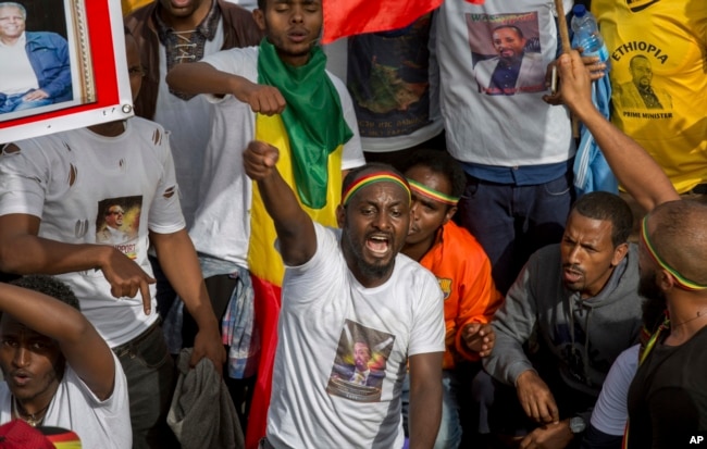 Ethiopians rally in solidarity with Prime Minister Abiy Ahmed, whose photo is seen on a participant’s T-shirt, in Meskel Square in the capital, Addis Ababa, Ethiopia, June 23, 2018.