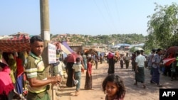 Rohingya refugees gather at a market as first cases of COVID-19 coronavirus have emerged in the area, in Kutupalong refugee camp in Ukhia on May 15, 2020. - Emergency teams raced on May 15 to prevent a coronavirus "nightmare" in the world's largest refuge