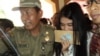 Kahiyang Ayu, daughter of Indonesian President Joko Widodo, is escorted by security as she arrives to take the civil service exam in the city of Solo, Central Java, Oct. 23, 2014. (Y. Satriawan / VOA)