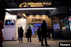 FILE - A sign of Alibaba Group is seen during the fourth World Internet Conference in Wuzhen, Zhejiang province, China, Dec. 3, 2017.