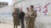 U.S. military and diplomatic delegations tour the city of Manbij, Syria, March 22, 2018.