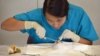 High school student Xing Zhang, 16, practices suturing at Fauquier Hospital’s Medical Camp in Warrenton, Virginia. (VOA/S. Logue)