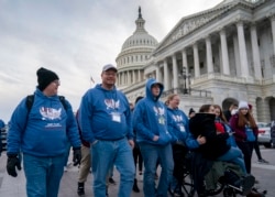 As the impeachment trial of President Donald Trump is conducted inside the Senate, activists attending the March for Life anti-abortion rally visit the Capitol in Washington, Thursday, Jan. 23, 2020.