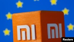 A 3D printed Xiaomi logo is seen in front of displayed EU flag in this illustration taken, Sept; 30, 2021. 