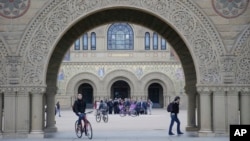 FILE - Students walk on campus at Stanford University Wednesday, Jan. 13, 2016, in Stanford, Calif. (AP Photo/Marcio Jose Sanchez)