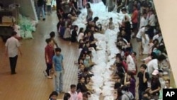 Volunteer relief workers prepare supplies at the Don Muang Airport, Thailand, October 15, 2011.