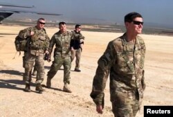 U.S. Army General Jospeh Votel, right, head of Central Command, visits an airbase at an undisclosed location in northeast Syria, Feb. 18, 2019.