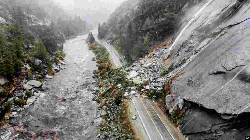 Rocks and vegetation cover Highway 70 following a landslide in the Dixie Fire zone, Oct. 24, 2021, in Plumas County, California.