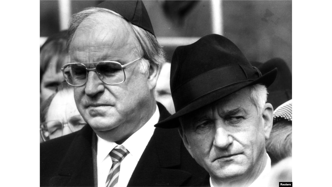 Helmut Kohl stands with former West German President Richard von Weizsaecker (R) in this April 21, 1985, file photo during a memorial ceremony marking the 40th anniversary of the liberation of the former Bergen Belsen concentration camp.