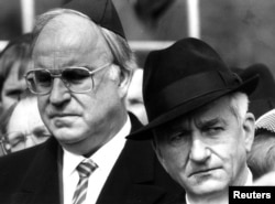 Helmut Kohl stands with former West German President Richard von Weizsaecker (R) in this April 21, 1985, file photo during a memorial ceremony marking the 40th anniversary of the liberation of the former Bergen Belsen concentration camp.