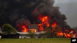 FILE - Fire engulfs the Branch Davidian compound near Waco, Texas on Monday, April 19, 1993.