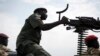 FILE - A government soldier mans a vehicle-mounted machine gun in the oil-rich town of Malakal, South Sudan.