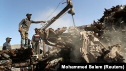 Palestinian workers sort scrap metals to be pressed in preparation for exports, at a scrap yard east of Gaza City January 25, 2021. (REUTERS/Mohammed Salem)