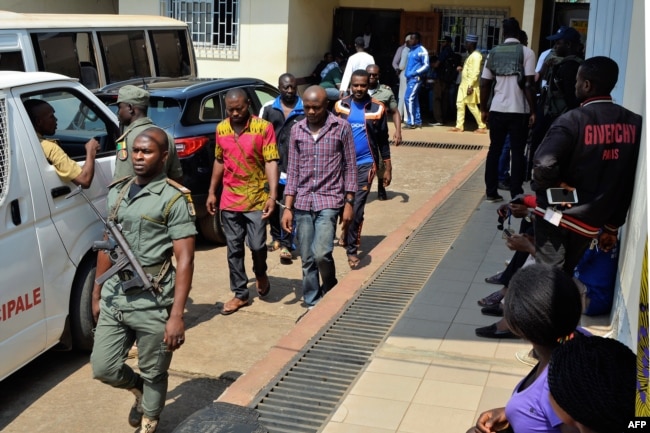 FILE - Men arrested in connection with Cameroon's anglophone crisis are seen at the military court in Yaounde, Cameroon, Dec. 14, 2018.