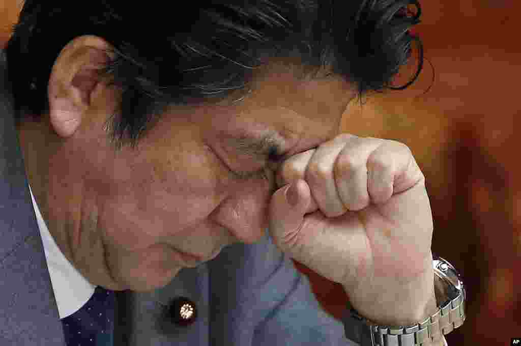 Japan's Prime Minister Shinzo Abe reacts during a session at the upper house of Parliament in Tokyo.