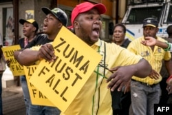 Supporters of the African National Congress Deputy President Cyril Ramaphosa hold placards and chant slogans during a demonstration to protest South African President and ANC member Jacob Zuma outside the ANC party headquarters in Johannesburg, Feb. 5, 2018.