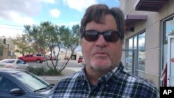 In this Nov. 3, 2016 photo, John Barnes, 60, of Albuquerque, N.M., speaks outside an early Albuquerque voting site about voting for Republican Donald Trump.