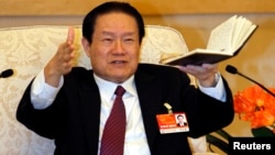 Chinese former Politburo Standing Committee Member Zhou Yongkang gestures as he speaks at a group discussion of Shaanxi Province during the National People's Congress at the Great Hall of the People in Beijing, in this picture taken March 12, 2011. 