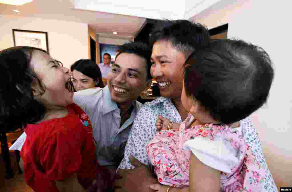 Reuters reporters Wa Lone and Kyaw Soe Oo celebrate with their children after being freed from prison, after receiving a presidential pardon in Yangon, Myanmar, May 7, 2019.