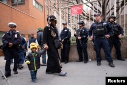 People leave the Islamic Cultural Center of New York under increased police security following the shooting in New Zealand, March 15, 2019, in New York.