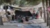 FILE - Displaced Iraqis from the Yazidi community gather at a park near the Turkey-Iraq border at the Ibrahim al-Khalil crossing on Aug. 15, 2014. 