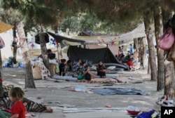 Displaced Iraqis from the Yazidi community gather at a park near the Turkey-Iraq border at the Ibrahim al-Khalil crossing, as they try to cross to Turkey on Aug. 15, 2014.