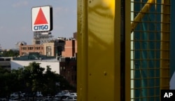 In this July 6, 2016 photo, the iconic Citgo sign is visible from the left field foul pole at Fenway Park in Boston.