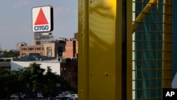 In this July 6, 2016 photo, the iconic Citgo sign is visible from the left field foul pole at Fenway Park in Boston.