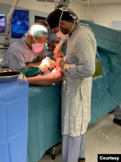 Dr. Bassam Osman (right) working under the supervision of his mentor, Dr. Jamil Borgi (far back of the photo). (Courtesy photo from Dr. Bassam Osman)