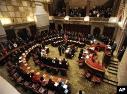 FILE - Members of New York's Electoral College meet in the New York state Senate Chamber to confirm the election of President Barack Obama and Vice President Joseph Biden, in Albany, New York, December 17, 2012.