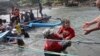 A rescuer carries a child after a boat carrying asylum seekers sank off Java island, in Cianjur, West Java, Indonesia, July 24, 2013.