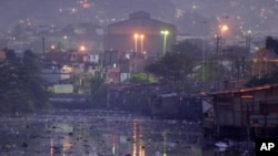 Waters of polluted Guanabara Bay pass through Manguinhos slum, Rio De Janeiro, undated file photo.