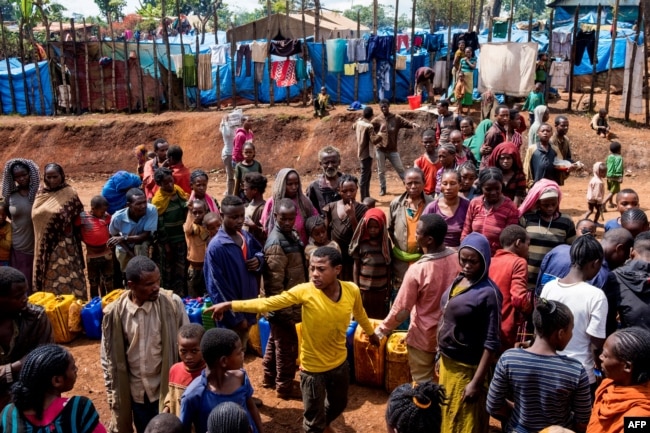 FILE - Displaced Gedeo people wait in line with their containers looking for water at Kercha site, West Guji in Ethiopia, Aug. 1, 2018.