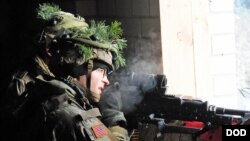 FILE - A U.S. paratrooper participates in a NATO exercise at an urban training center in Pabrade, Lithuania.
