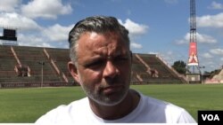 FILE — Mark Fish, a retired South African football player, listens during an interview with VOA, March 14, 2020