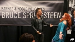 Bruce Springsteen greets a fan at the launch of his autobiography, "Born to Run," at the Barnes & Noble in Freehold, N.J., the town where he grew up, Sept. 27, 2016.