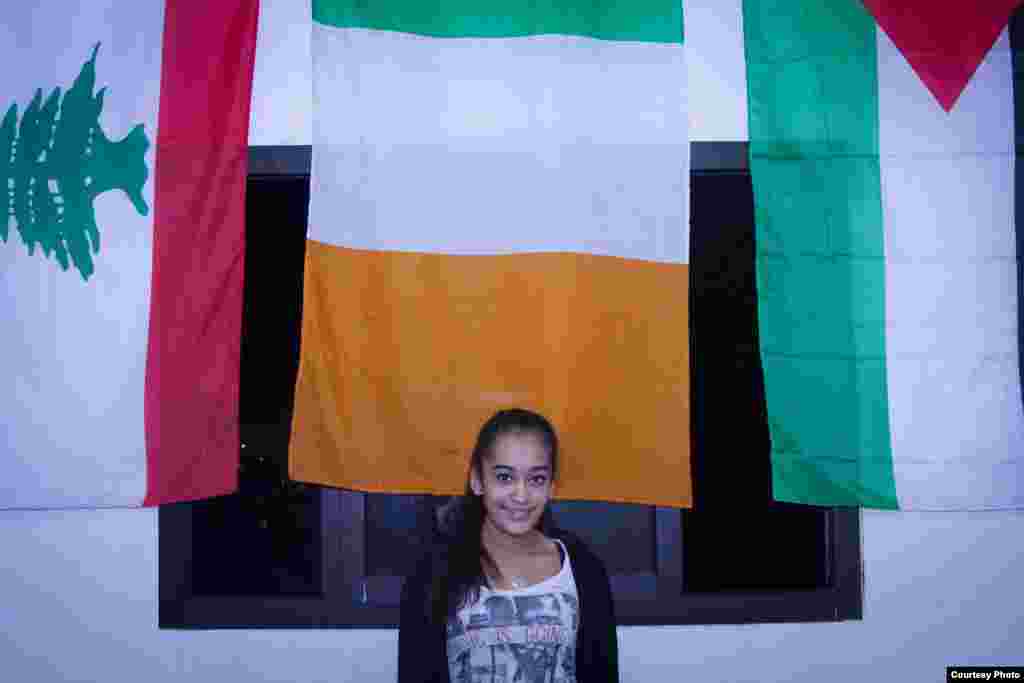 Gulizar Osman, who plays for the girls basketball team, stands in front of the flag of Ireland because supporters who help fund the team are from Ireland. Coach Majdi calls them &quot;the Irish delegation.&quot; (John Owens/VOA)
