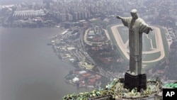 A 2007 file photo of people waving flags at the Christ the redeemer statue in Rio de Janeiro after Brazil was officially chosen by FIFA as host of the 2014 World Cup