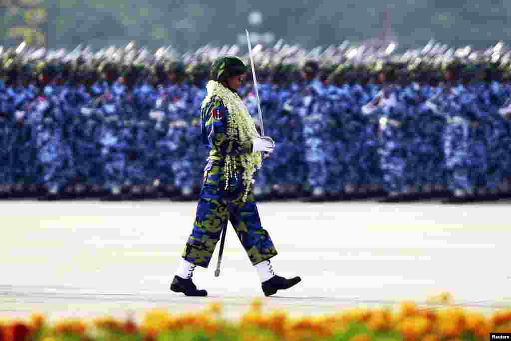 An honor guard marches during a parade to mark the 68th anniversary of Armed Forces Day in Burma's capital Naypyitaw, March 27, 2013. 