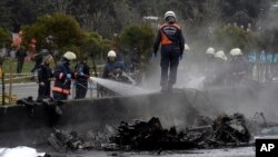 Firefighters work on the site shortly after a helicopter with seven people inside was crashed in Istanbul's Buyukcekmece district, March 10, 2017. 