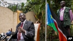 FILE - South Sudan's rebel leader Riek Machar, left, speaks to the media about the situation in South Sudan following last week's peace agreement with the government, in Addis Ababa, Ethiopia,Aug. 31, 2015. 