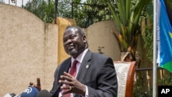 FILE - South Sudan's rebel leader Riek Machar, left, speaks to the media about the situation in South Sudan following last week's peace agreement with the government, in Addis Ababa, Ethiopia, Aug. 31, 2015. 