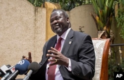 FILE - South Sudan's Riek Machar speaks to reporters following the signing of the peace agreement with the South Sudan government, in Addis Ababa, Ethiopia, Aug. 31, 2015.