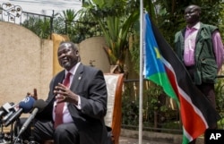 FILE - South Sudan's rebel leader Riek Machar, left, speaks to the media about the situation in South Sudan following last week's peace agreement with the government, in Addis Ababa, Ethiopia, Aug. 31, 2015.