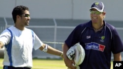 FILE - Sachin Tendulkar, left, shares a laugh with Shane Warne during a 2004 training session in Bombay.