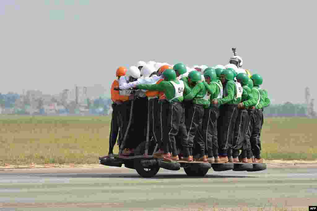Members of the Tornadoes motorcycle display team of the Army Service Corps (ASC) on the final run for the World Record for carrying 58 men on a single 500 cc motorcycle in Bangalore.