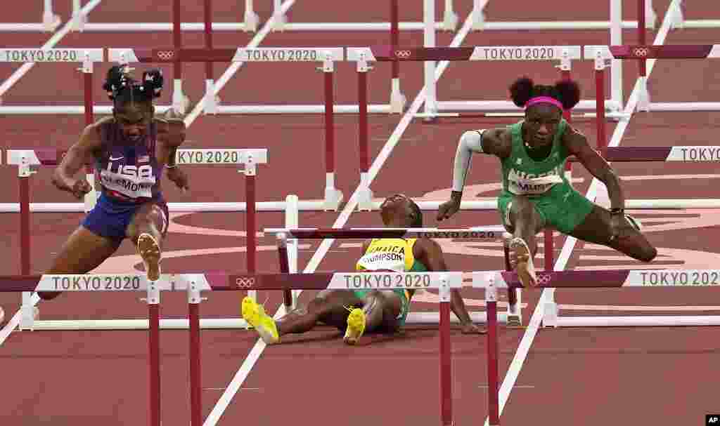 Yanique Thompson, of Jamaica, center, reacts as she pulls up during a women&#39;s 100-meter hurdles semifinal at the 2020 Summer Olympics, Sunday, Aug. 1, 2021, in Tokyo, Japan. At left is Christina Clemons, of United States, and at right, Tobi Amusan, of Nigeria. (AP Photo/Charlie Riedel)