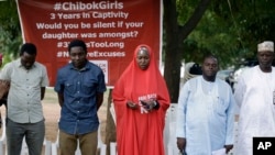 Campaigners observe a minute silent for the remaining Kidnapped schools during their daily sit outs in Abuja, May 9, 2017. 