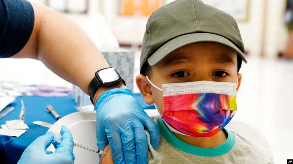 Oliver Estrada, 5, receives the first dose of the Pfizer COVID-19 vaccine at an Adelante Healthcare community vaccine clinic at Joseph Zito Elementary School, Nov. 6, 2021, in Phoenix, Arizona. (AP Photo/Ross D. Franklin)